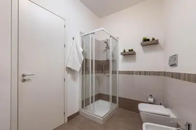 a bathroom with a shower and a toilet at Borsa Apartments by Wonderful Italy in Palermo
