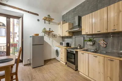 a kitchen with stainless steel appliances and wooden cabinets at Borsa Apartments by Wonderful Italy in Palermo