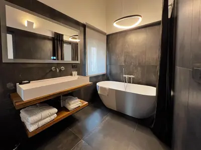 a bathroom with a large tub and a sink at Gioiamia - Luxury Rooms in Cattedrale in Palermo