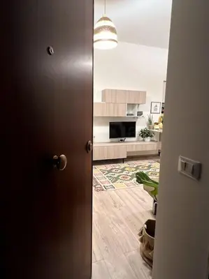 a door leading into a room with a kitchen at Carducci apartment in Palermo