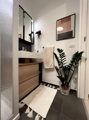 a bathroom with a sink and a potted plant at Carducci apartment in Palermo