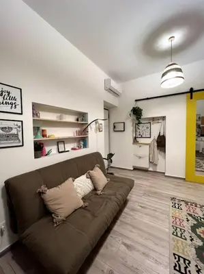 a living room with a brown couch in a room at Carducci apartment in Palermo