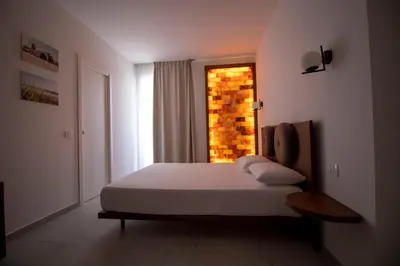 a bedroom with a bed and a window at Hotel Arte Mare in San Vito lo Capo