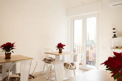 a dining room with a table and chairs and a window at Il gabbiano a Ballarò in Palermo