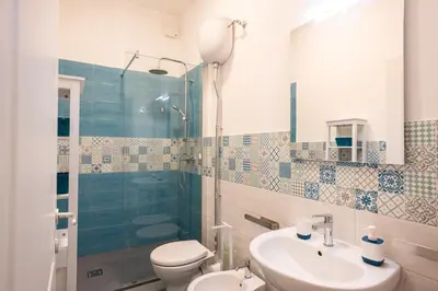 a bathroom with a toilet and a sink and a shower at Il gabbiano a Ballarò in Palermo