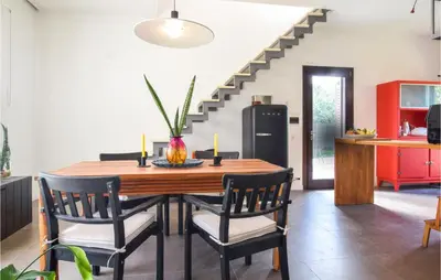 a dining room with a table and chairs and a staircase at Gorgeous Home In Trabia With Wifi in Trabia