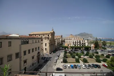 a city with cars parked in a parking lot at Stunning Kalsa in Palermo