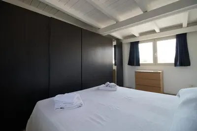 a bedroom with a bed with two white towels on it at Stunning Kalsa in Palermo