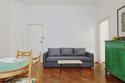 a living room with a couch and a table at GuestHost - Teatro Massimo Lovely Flat with Balconies in Palermo