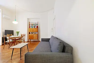 a living room with a couch and a table at GuestHost - Teatro Massimo Lovely Flat with Balconies in Palermo