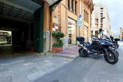 a motorcycle parked in front of a building at GuestHost - Teatro Massimo Lovely Flat with Balconies in Palermo