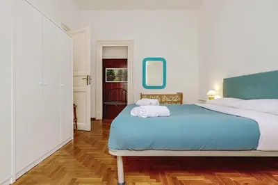 a bedroom with a bed with two towels on it at GuestHost - Teatro Massimo Lovely Flat with Balconies in Palermo