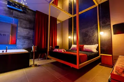 a bedroom with a canopy bed and a tub in it at GOLD SUITE&SPA in Palermo