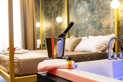 a bathroom with a sink and a bottle of wine at GOLD SUITE&SPA in Palermo
