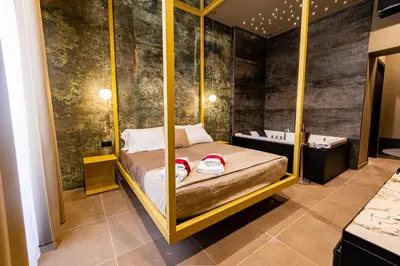 a room with a bed and a bath tub in a room at GOLD SUITE&SPA in Palermo