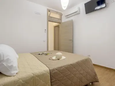 a bedroom with a bed with a hat on it at Apartment Sole by Interhome in Balestrate