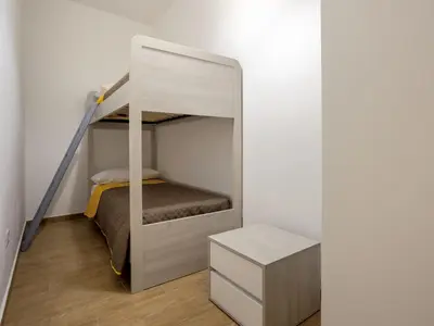 a small bedroom with a bunk bed and a drawer at Apartment Sole by Interhome in Balestrate