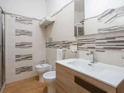 a bathroom with a white toilet and a sink at Apartment Sole by Interhome in Balestrate