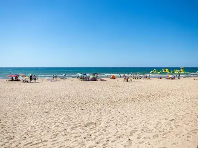 a group of people on a beach near the ocean at Apartment Sole by Interhome in Balestrate