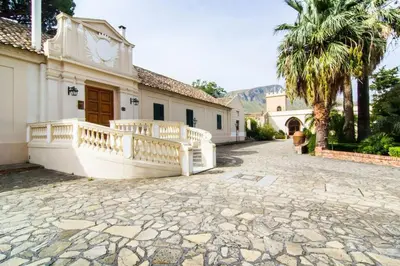 a house with a balcony and a stone driveway at Allegroitalia Torre Artale Palermo in Trabia