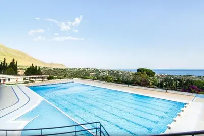 a large swimming pool with a view of the ocean at Allegroitalia Torre Artale Palermo in Trabia