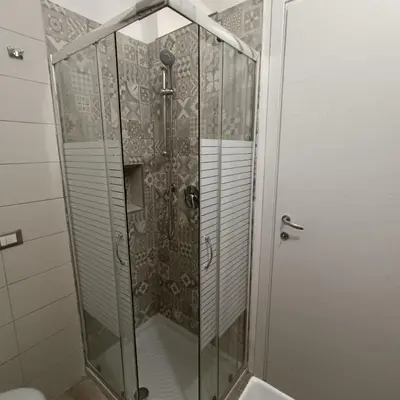 a shower with a glass door in a bathroom at Casa alla Stazione in Palermo
