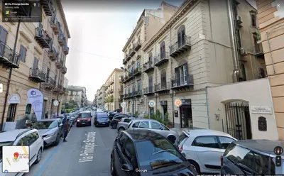 a street with cars parked on the side of the road at Casa di Giulietta in Palermo