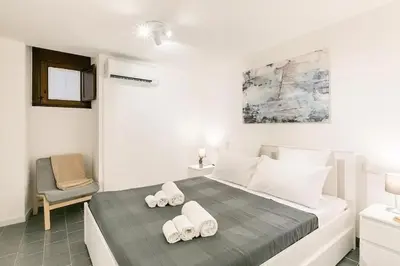 a bedroom with a bed with two towels on it at Casa Musicò in Palermo