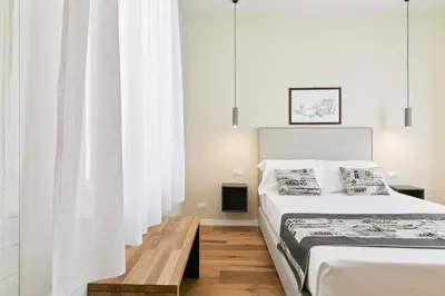 a bedroom with two beds and white curtains at GuestHost - NotHotel Palermo Central Bright Apartment in Palermo