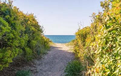 a dirt path leading to the ocean on a beach at Lovely Home In Piane Vecchie,Lascari in Lascari