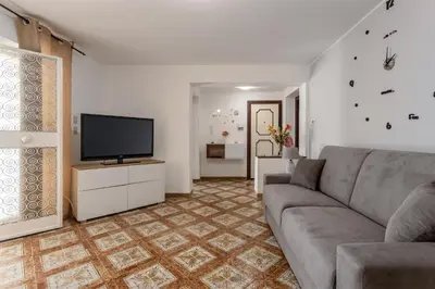 a living room with a couch and a flat screen tv at Casa in Villa a Mondello-700m dal mare in Palermo