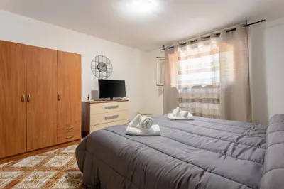 a bedroom with a large bed with towels on it at Casa in Villa a Mondello-700m dal mare in Palermo