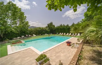 a swimming pool in a yard with chairs and trees at Amazing Home In San Giuseppe Jato in San Giuseppe Jato