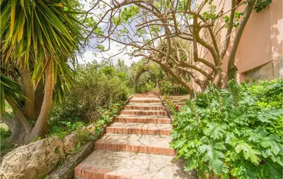 a garden path with trees and plants at Amazing Home In San Giuseppe Jato in San Giuseppe Jato