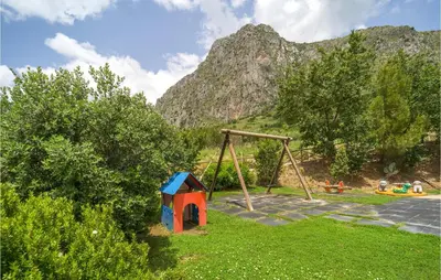 a playground with a swing and a play set at Rosmarino in San Giuseppe Jato
