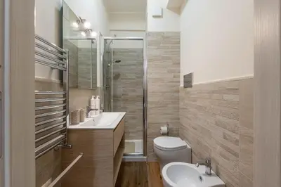 a bathroom with a toilet and a sink and a shower at Appartamento Libertà con Terrazza by Wonderful Italy in Palermo