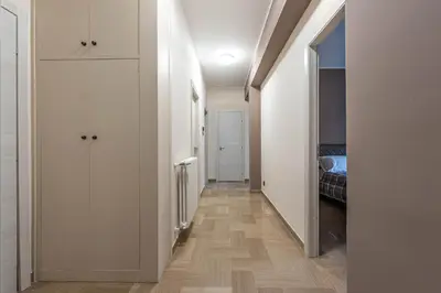 a hallway with white cabinets and a bedroom at Appartamento Libertà con Terrazza by Wonderful Italy in Palermo