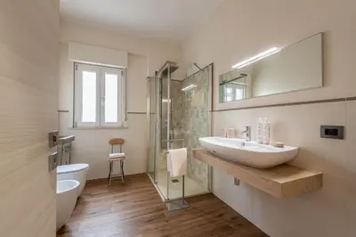 a bathroom with a sink and a toilet and a mirror at Appartamento Libertà con Terrazza by Wonderful Italy in Palermo