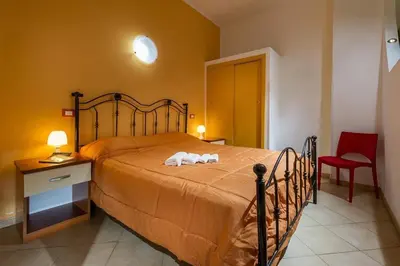 a bedroom with a bed with two towels on it at Principe Tancredi in Castellammare del Golfo