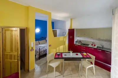 a kitchen with a table and chairs in a room at Principe Tancredi in Castellammare del Golfo