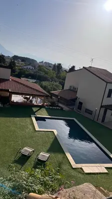 an overhead view of a swimming pool with two chairs and a house at Villa Laura in Cefalù