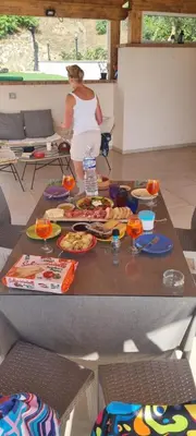 a woman standing behind a table with food on it at Villa Laura in Cefalù