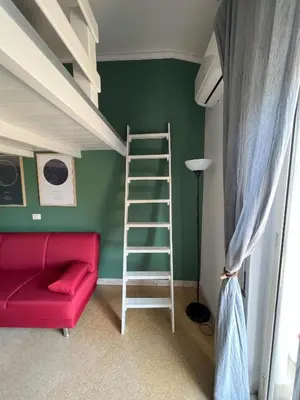 a living room with a red couch and bunk beds at S&S in Palermo