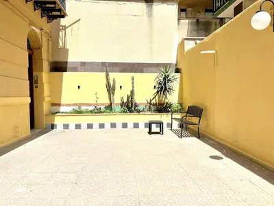 a empty courtyard with a bench and plants in a building at Palermo Central in Palermo