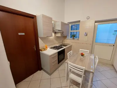 a kitchen with a table and a stove top oven at CASA di ARTHUR in Palermo