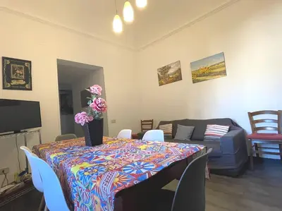 a room with a table with a vase of flowers on it at Residenza Lincoln in Palermo