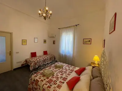 a bedroom with a bed and a couch in a room at Residenza Lincoln in Palermo