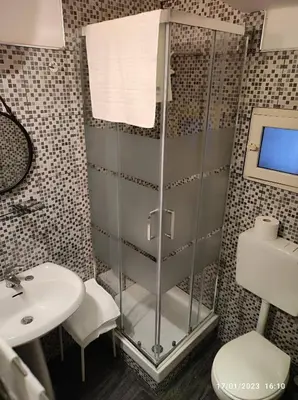 a bathroom with a shower and a sink at Montesanto House Palermo in Palermo