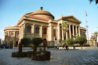 a large building with people walking in front of it at Montesanto House Palermo in Palermo