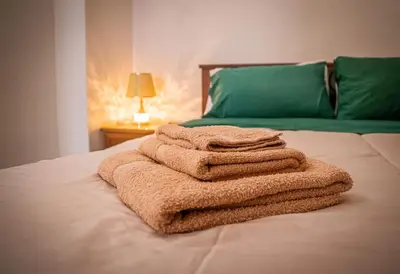 a pile of towels sitting on top of a bed at Ciuri Ciuri in Isola delle Femmine
